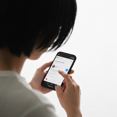 Person interacting with social media on a smartphone, showing personalized content